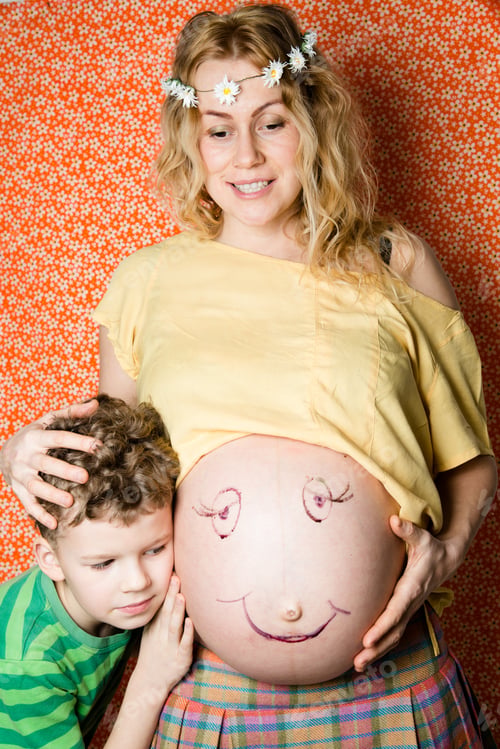 Preview: The Child Clung To The Tummy Of A Pregnant Mother. Pregnant Woman Smiling
