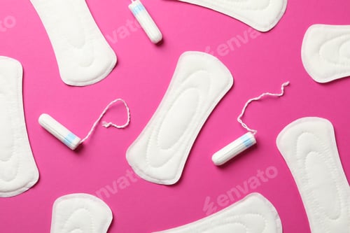 Preview: Sanitary pads and tampons on pink background, top view