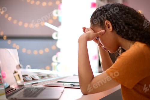 Preview: Stressed Teenage Girl At Home In Bedroom Studying Using Laptop Computer