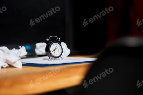 Preview: Modern workplace, wooden office desk in hardlight, sunligt with clock, sheet of paper
