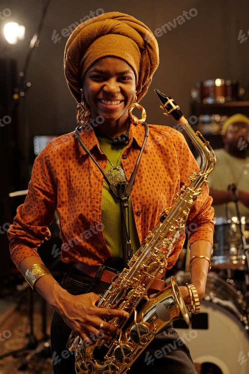 Preview: Smiling African American Musician Holding Saxophone
