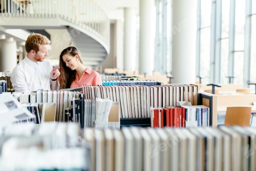 Preview: Two students reading and studying in library