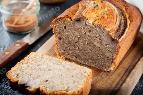 Preview: Banana bread and bananas on a dark background. Top view. Selective focus