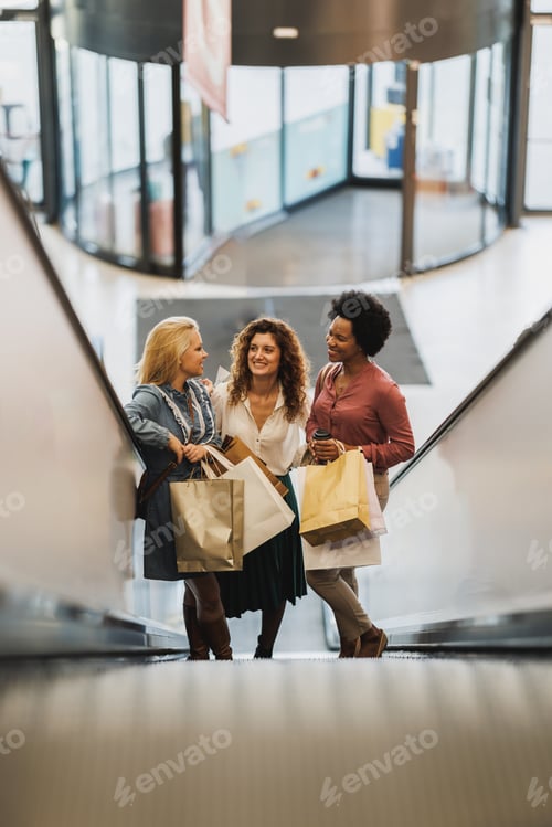 Preview: Women Friends With Shopping Bags On Escalator In A Mall