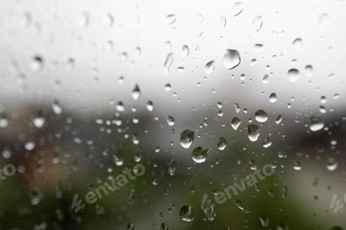 Preview: Bright window covered in numerous water droplets