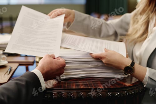 Preview: Businesswoman Giving Paper to Her Male Colleague