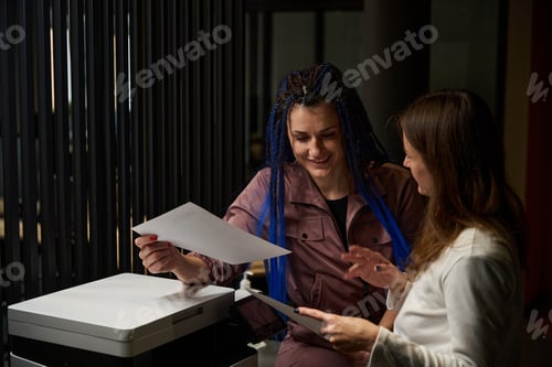 Preview: Female colleagues making copies of private documents of office employees