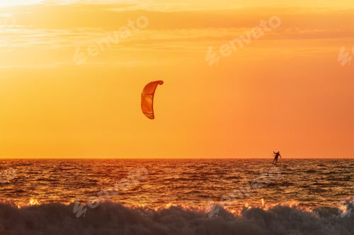 Preview: Kiteboarding kitesurfing kiteboarder kitesurfer kites silhouette in the ocean on sunset