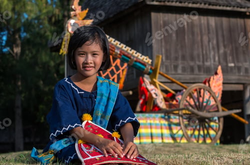 Preview: raditional beautiful girl with Ancient rocket with cart on parades showing in Rocket festival