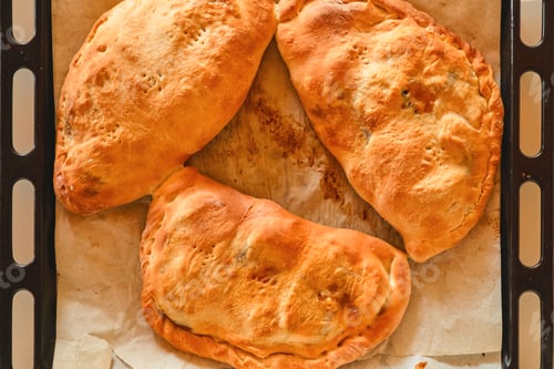 Preview: Homemade calzones cooling on a baking sheet