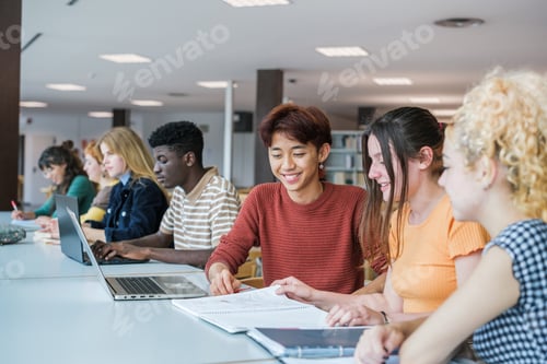 Preview: Group of students of different nationalities studying together in the university library