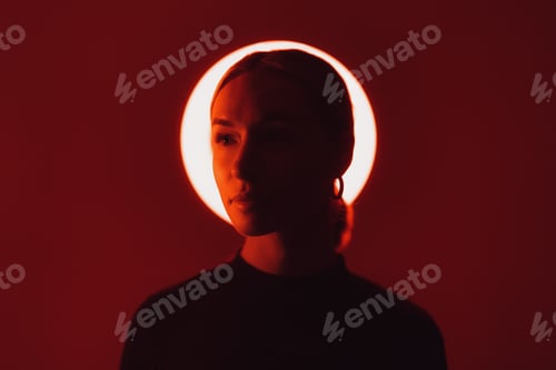 Preview: Woman in neon light against red backdrop
