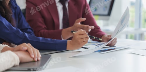 Preview: Business team reviewing financial documents during office meeting
