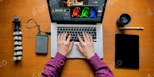 Preview: male producer edit video on his laptop in studio b