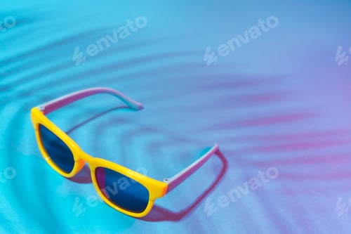 Preview: Close-up Image Of Sunglasses On Turquoise Blue Background With Palm Tree Shadow