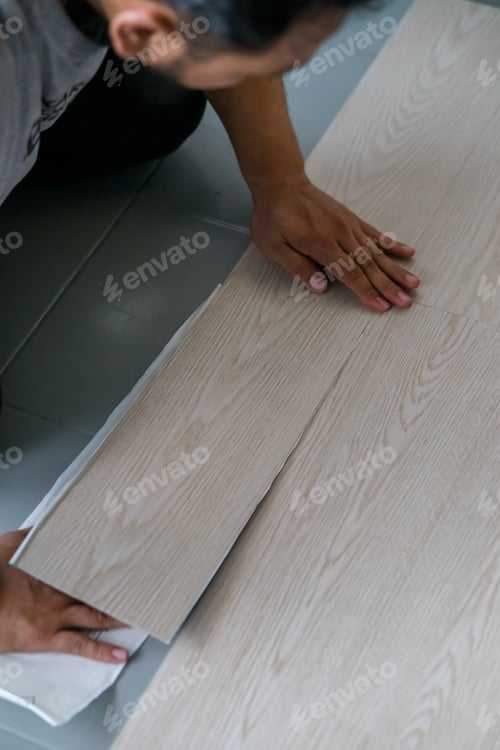 Preview: Vinyl floor installation, worker, DIY at home.