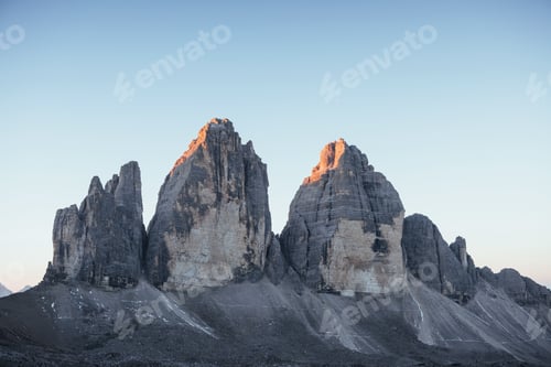 Preview: Three peaks Tre Cime mountains in the morning with clear sky over it