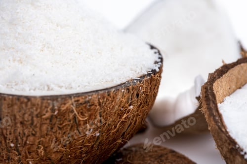 Preview: close up view of ripe organic coconut with sweet shavings isolated on white