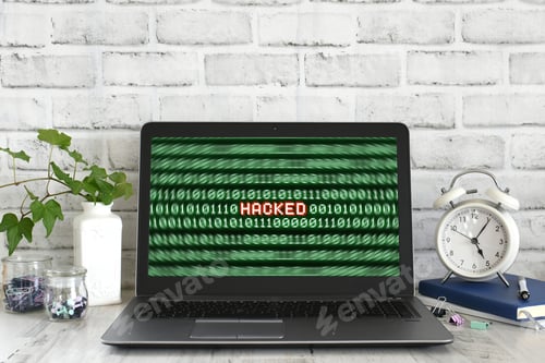 Preview: Laptop computer with a Hacked warning on the screen. Concept for hacker cyber attack danger