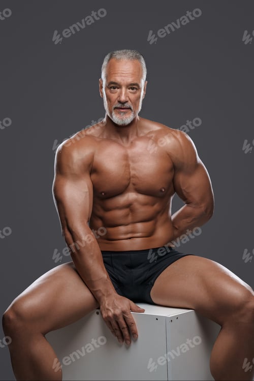Preview: Handsome, toned male model with a stylish gray beard
