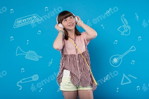 Preview: Music Lover. Happy Cheerful Girl Smiling And Feeling Good While Listening To Music In Big Headphones