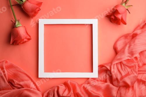 Preview: Flat lay composition with frame, roses and fabric on coral background. Space for text