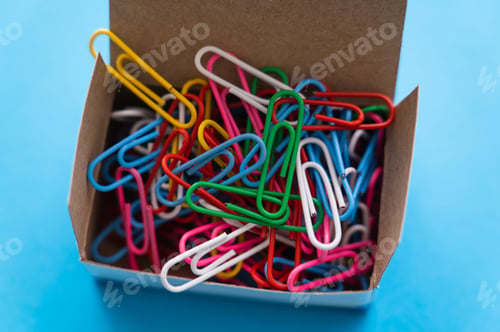 Preview: close up view of box with colorful paper clips on blue