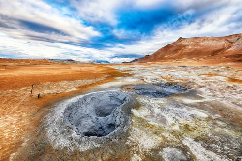 Preview: Breathtaking boiling mudpots in geothermal area Hverir and cracked ground around.