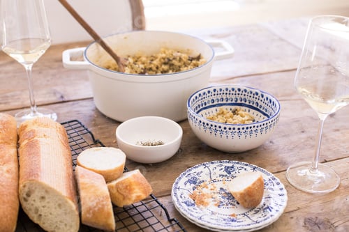 Preview: Enticing kitchen scene with freshly baked baguettes and a bowl of cooked rice served with wine