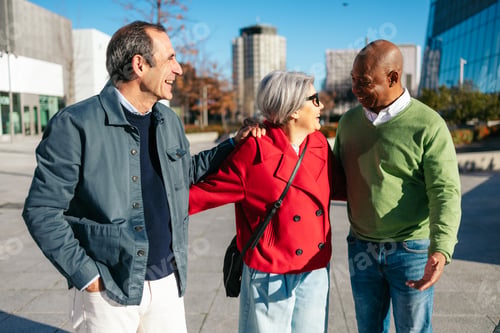 Preview: Three senior friends sharing a joyful moment in a city setting