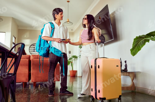 Preview: Tourists arriving at hotel lobby handing over passport to receptionist