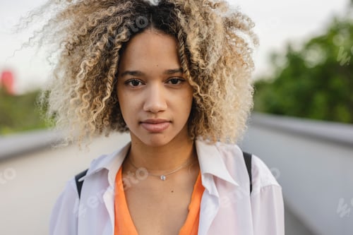 Preview: Young Woman with Curly Hair in Casual Outfit
