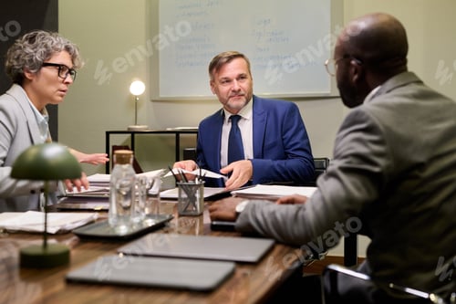 Preview: Middle Aged Caucasian Man Leading Business Meeting with Diverse Colleagues