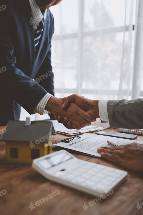 Preview: Real estate broker and client shaking hands after signing sale contract, home loan and congratulatin