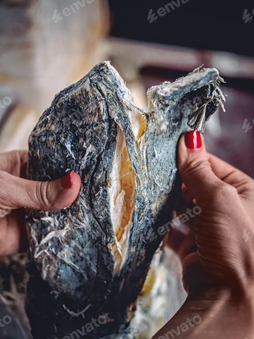 Preview: cropped shot of woman holding homemade molded chechil cheese