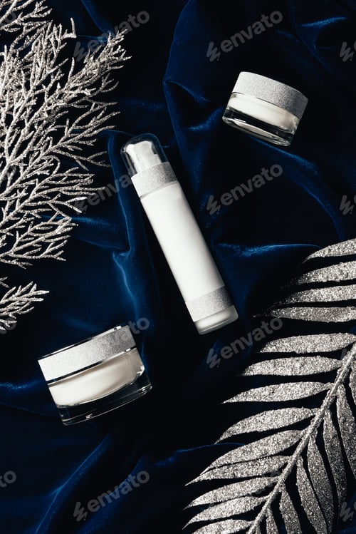 Preview: view from above of lotion and beauty cream between christmas silver branches on velvet surface