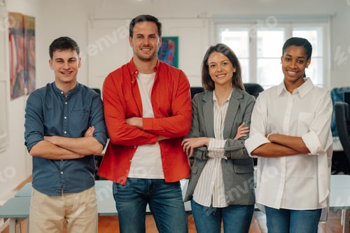 Preview: Startup business team smiling with folded arms in office