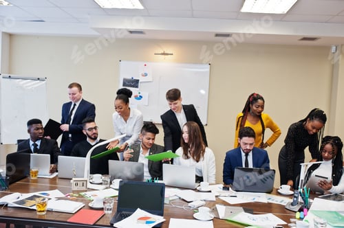 Preview: Multiracial young creative people in modern office