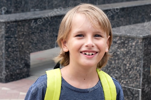 Preview: Back to school Happy blonde boy pupil with green backpack smile at camera Portrait