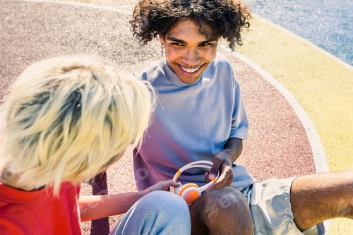 Preview: Interracial young couple dating outdoors, colored and modern urban background