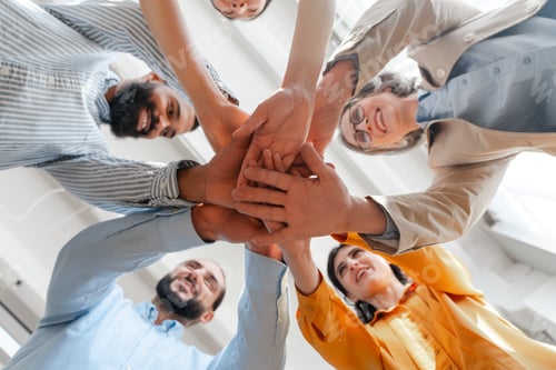 Preview: Diverse group of business people joining hands in circle selective focus