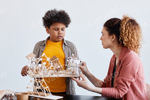 Preview: Boy Presenting Art Project in School