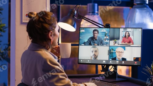 Preview: Young employee meeting with people on videocall
