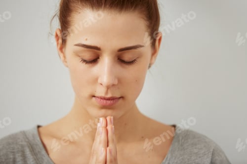 Preview: Woman Meditating with Hands Clasped Under Chin