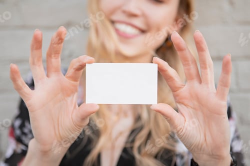 Preview: Cheerful white woman showing her business card