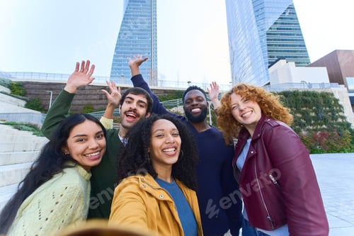 Preview: Happy multi ethnic friends taking selfie waving at camera