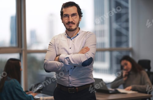 Preview: Authentic looking Turkish man in a modern office with his colleagues.