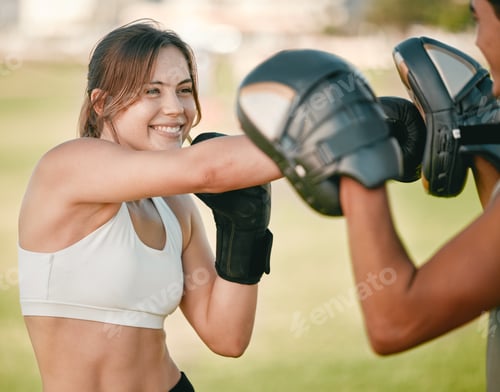 Preview: Woman, boxing and personal trainer exercise outdoor in nature park for fitness, health and wellness
