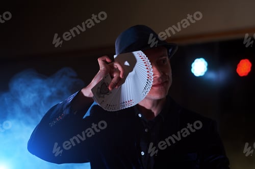 Preview: Magician showing trick with playing cards. Magic or dexterity, circus, gambling
