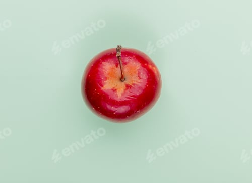 Preview: top view of red apple on green background with copy space